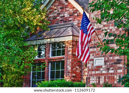 Patriotic American flag in front of southern home