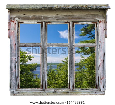 Scenic view across a river with trees, seen through an old rustic window frame