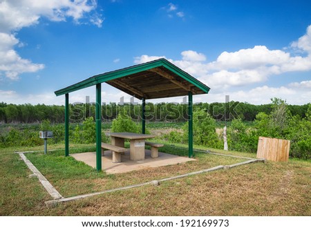 Picnic area with table and grill in a park