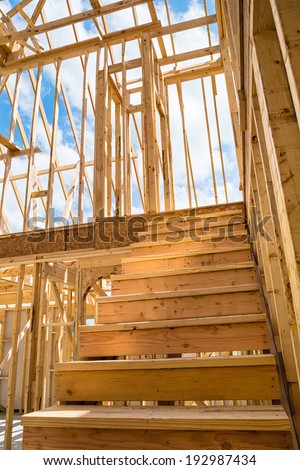 Unfinished residential construction house framing, closeup of interior stairs