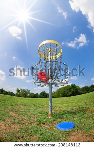 Disc golf hole basket against blue sky