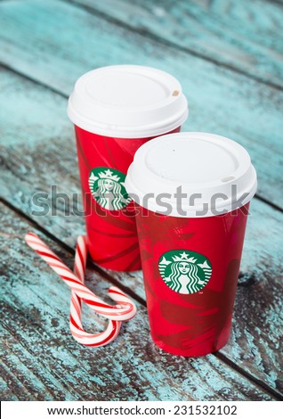 DALLAS, TX - NOVEMBER 18, 2014: A cup of Starbucks popular holiday beverage, peppermint mocha, displayed with candy canes on wooden table.