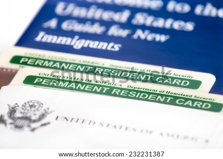 United States of America permanent resident cards, green card. Immigration concept. Closeup with shallow depth of field.