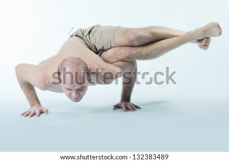 Portrait of strong man sitting in yoga pose