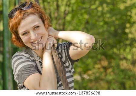 Portrait of beautiful smiling red hair girl with sun glasses