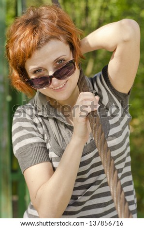 Portrait of beautiful smiling red hair girl with sun glasses