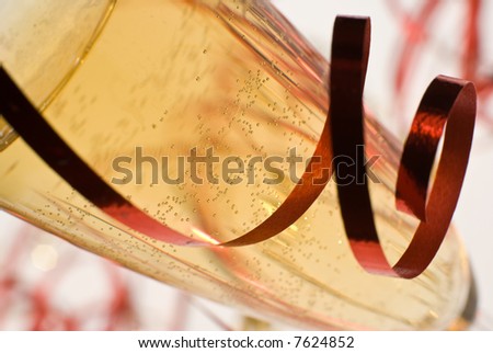 Champagne flute detail with ribbon - shallow dof, focus on the bubbles.