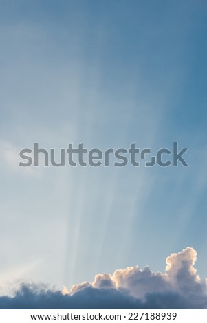 Blue sky and sunlight through clouds in vertical