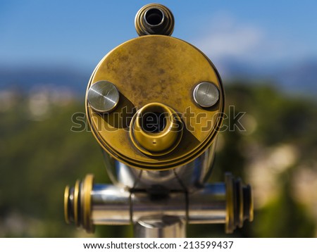 A picture of an ancient colorful coin binocular face