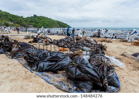 RAYONG,THAILAND-July 31 : Plenty of big bags which contain of crude oil and sand inside and wait for remove on Ao Prao Beach at Samet island on July 31,2013 in Rayong,Thailand