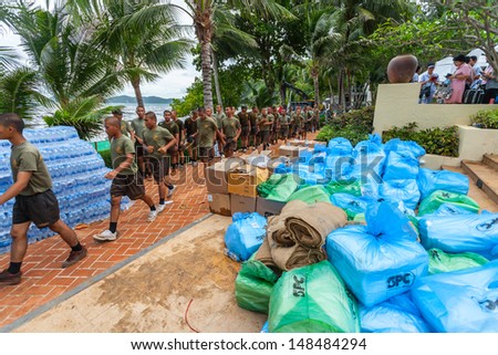 RAYONG,THAILAND-July 31 : Plenty of Royal Thai Navy soldier come to help and clean the crude oil on oil spill accident by PTT on Ao Prao Beach at Samet island on July 31,2013 in Rayong,Thailand
