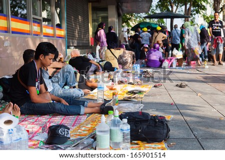 BANGKOK,THAILAND-DECEMBER 2 : Some protesters was tired after fight all day , they all sleep on foot part and street on  Ratchadumnoen road in Bangkok on December 2,2013 in Bangkok,Thailand