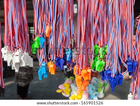 BANGKOK,THAILAND-DECEMBER  : Plenty of whistles was sale for protesters,the whistle is the symbol for against the government on Ratchadumnoen road in Bangkok on December 2,2013 in Bangkok,Thailand
