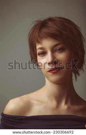 portrait of a young woman with short brown hair and brown glowing eyes