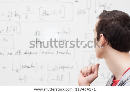 Thinking boy with whiteboard solving equation