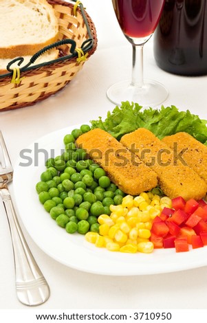Fish fingers with vegetables and a glass of wine