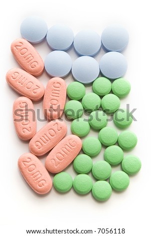 red green and blue pills arranged on white background