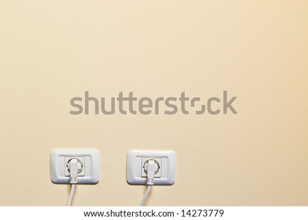 electric consumption - two socket on beige wall