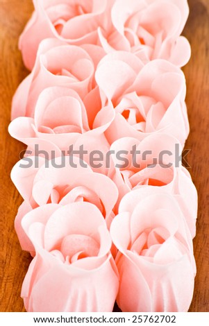 pink soap flowers in wood tray