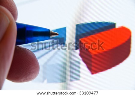 closeup of pen showing pie graph on screen