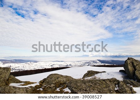 winter mountains with snow and clouds in day light