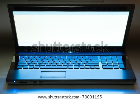 laptop computer with screen half open on dark background isolated with clipping path
