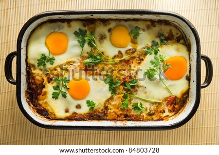 eggs fried with parsley on top of cooked rice meal