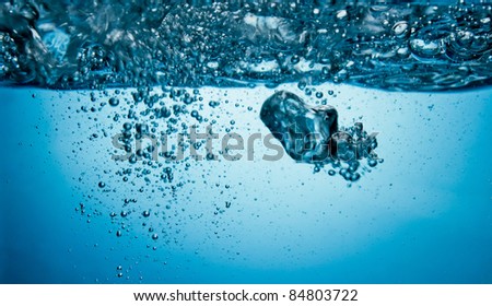 air bubbles underwater in blue light