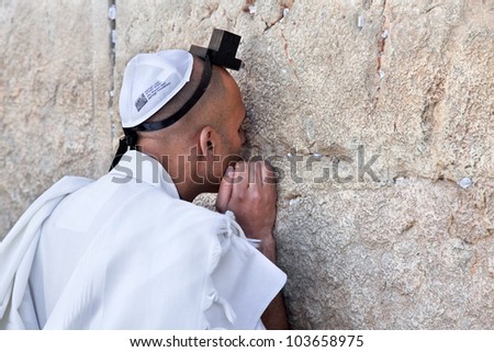 JERUSALEM, ISRAEL - APRIL 26: An unidentified Jewish man praying at the western wall on a jewish holiday Israel\'s 64th Independence Day on April 26, 2012 in Jerusalem, Israel