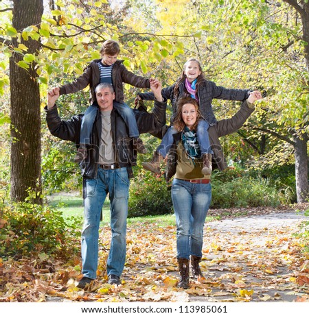 Happy family  relaxing outdoors In autumn park - stock photo