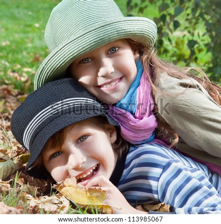 Portrait of happy girl and boy  enjoying golden autumn fall season