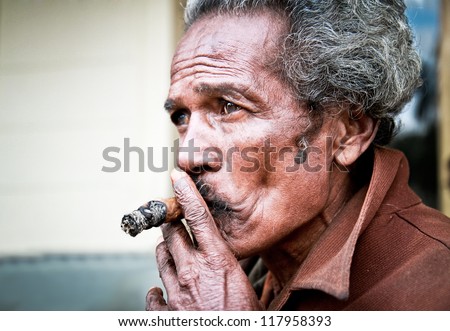 SANTA CLARA,CUBA-JAN 10:Unidentified Cubans smoking cigar on Jan  10. 2010.Santa Clara,Cuba.Cubans of all ages are actively smoking cigars.All production in Cuba is controlled by the Cuban government