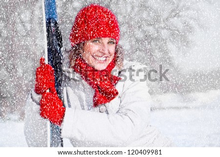 Beautiful woman with snowboard on the snow day. Winter concept.