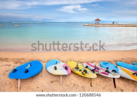 Surf boards on idyllic tropical sand Nusa Dua beach, Bali, Indonesia.