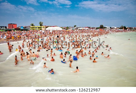 COSTINESTI, ROMANIA - AUGUST 8: Crowded beach with tourists in summer on August 8, 2012 in Costinesti, Romania. Costinesti is a famous summer destination for hundred of thousands of tourists a year.