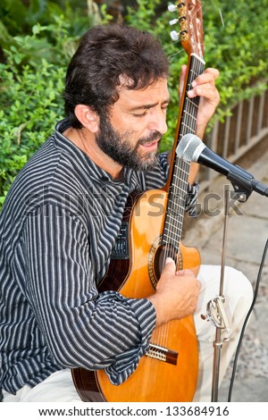 SEVILLE, SPAIN - SEP 11: Male musician playing in the street for money on Sep 11, 2011, in Seville, Spain.