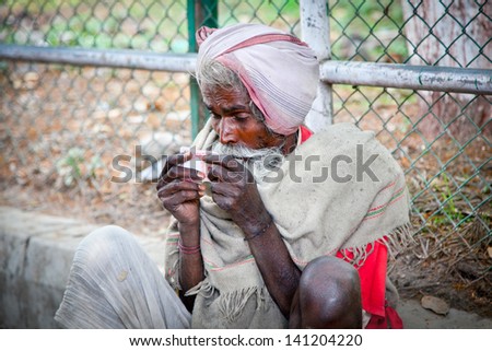 KATHMANDU, NEPAL - MAY 18: Unidentified homeless person begs on the street on May 18, 2013 in Kathmandu, Nepal. Around 2.8 million people in Nepal live in slums or on the streets.