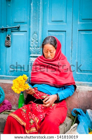 KATHMANDU, NEPAL - MAY 19: Unidentified flower vendor at the flower market on May 19, 2013 in Kathmandu, Nepal. This is a small market for retail florists and street vendors.