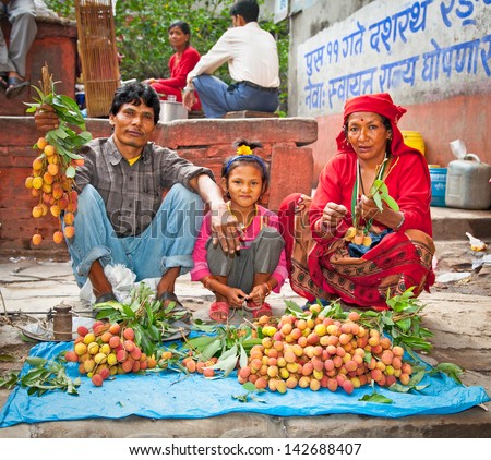 Kathmandu, Nepal - May 19: Family Sell Lychee Fruits On A Street Market In Kathmandu On May 19, 2013. On United Nations List Nepal As One Of The Least Developed Country In The World.