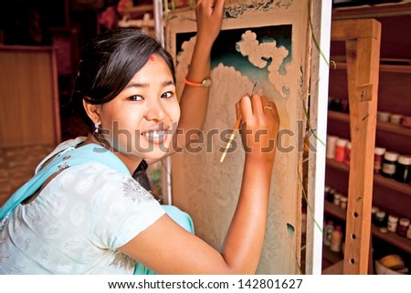 KATHMANDU, NEPAL - MAY 19: Nepalese woman drawing traditional painting on May 19, 2013 in Kathmandu , Nepal. On United Nations list Nepal as one of the Least developed country in the world.