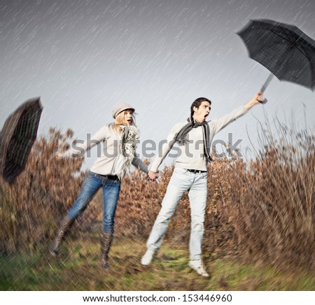 Woman and man with umbrellas during strong storm wind. Autumn set.