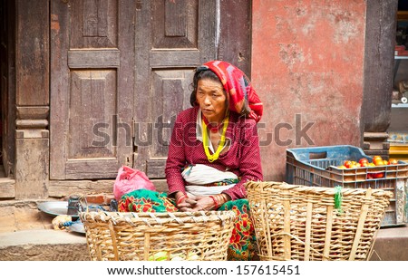 BHAKTAPUR, NEPAL - MAY 20: Woman sell fruits on a street market in Bhaktapur,Nepal, on May 20, 2013. On United Nations list Nepal as one of the Least developed country in the world.