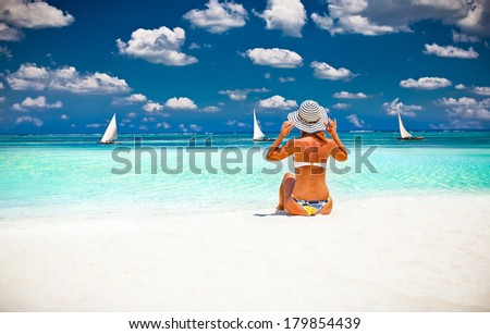 Young fashion woman relax on the beautiful tropical beach in Africa.