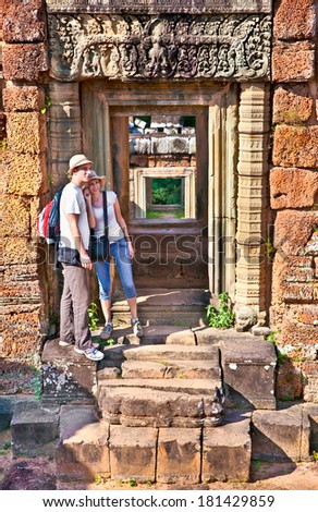 Beautiful young couple at door of Prasat Pre Roup temple in Angkor wat complex, near Siem Reap, Cambodia.