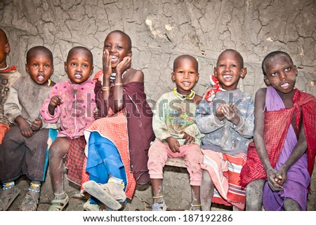 AFRICA, TANZANIA-FEBRUARY 9, 2014: Portrait on unidentified African Kids of Masai  tribe village smiling to the camera,  living in house made with cow dung , February 9, 2014. Tanzania.