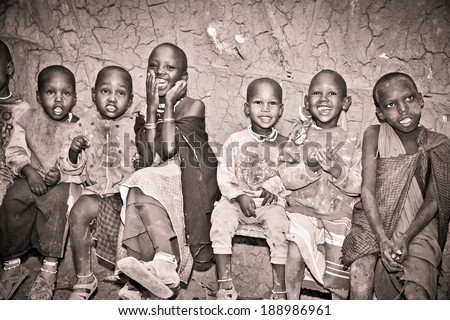 AFRICA, TANZANIA-FEBRUARY 9, 2014: Portrait on an African Kids of Masai  tribe village smiling to the camera,  living in house made with cow dung , February 9, 2014. Tanzania.