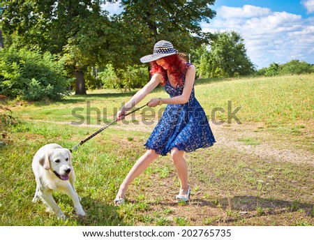 Elegant woman walking her big dog in the park,  Serbia.