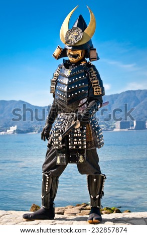 MIYAJIMA,JAPAN-OCT 19, 2014: Japanese man in samurai costume on Oct 19, 2014 in Miyajima, Japan. Samurais were the soldiers in the shogun\'s army and they were feared all over Japan in the Middle Ages.