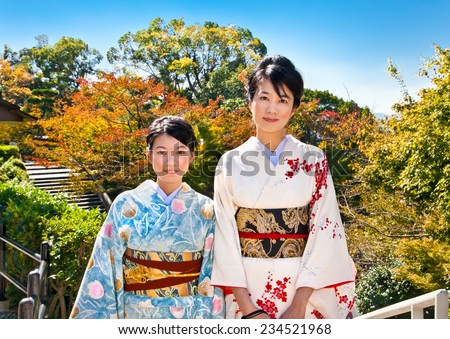 KYOTO - OCT 24,2014: Two japanese women with traditional kimono in fall park on Oct 24, 2014,Kyoto, Japan. Viewing the fall foliage is a cultural pastime in Japan dating from antiquity.