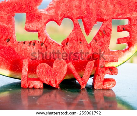 Fresh juicy watermelon slice  with love letters word on table